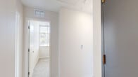 Located at 1667 Snelling Ave N in Falcon Heights, Minnesota, this two-bedroom, one-bathroom unit offers a thoughtfully designed single-floor layout with a clean, modern aesthetic. The open-concept kitchen and living area serves as the heart of the space, where light wood-style flooring flows throughout. The kitchen is well-appointed with rich dark cabinetry, light countertops, a full suite of stainless steel appliances including a range, microwave, dishwasher, and refrigerator, and track lighting overhead that adds a contemporary touch. The living area benefits from large windows dressed with blinds, inviting generous natural light and views of the surrounding neighborhood. Both bedrooms feature plush carpeting and neutral walls, creating a calm and comfortable atmosphere. The primary bedroom is a well-proportioned retreat, while the second bedroom includes a double-door closet for ample storage. The bathroom is finished with light tile flooring, dark wood vanity cabinetry with a white countertop, a full tub-shower combination, and recessed lighting, offering a clean and functional design. Neutral tones and consistent modern finishes tie the entire space together cohesively.