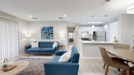 Located in Atlanta, GA, this single-floor, 3-bedroom, 2-bathroom home offers a thoughtfully designed open-concept layout that maximizes its efficient footprint. The living room serves as a welcoming centerpiece, featuring light wood-style flooring, recessed lighting, and a large sliding glass door dressed with floor-to-ceiling vertical blinds that flood the space with natural light and offer outdoor views. The kitchen is a standout feature, showcasing crisp white shaker cabinetry, a classic subway tile backsplash, stainless steel appliances, and a generous peninsula with a quartz countertop and undermount sink, accented by stylish pendant lighting. The adjacent dining area provides an intimate setting, complemented by light-toned flooring and neutral walls. The spacious primary bedroom is carpeted and features a large window with garden views, offering a calm and restful retreat. Two full bathrooms include tub-shower combinations with clean white tile surrounds and updated white vanities with modern hardware. Additional highlights include a dedicated closet, a cozy window nook with outdoor greenery views, and a cohesive neutral color palette throughout that lends a clean, modern ambiance to the entire home.