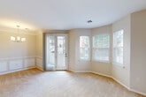 Located at 3601 W Broadway in Columbia, Missouri, this single-floor, one-bedroom, one-bathroom residence offers a practical and comfortable layout designed to maximize every square foot. The combined dining room, kitchen, and living area forms the heart of the home, creating an open-concept space bathed in natural light from multiple windows and a glass-paned exterior door that opens to a private outdoor area. Soft carpet flows throughout the living spaces, while the kitchen and bathroom feature warm hardwood-style flooring. The kitchen is outfitted with crisp white cabinetry, light stone countertops, an undermount sink, and a full-size refrigerator, providing ample storage and functionality. The bedroom is a well-proportioned retreat, complete with a ceiling fan, a window with outdoor views, and access to two closets for generous storage. The bathroom includes a full tub-shower combination with tile surround, white cabinetry, and hardwood-style flooring. A dedicated in-unit laundry area adds everyday convenience. Neutral tones, clean lines, and an abundance of natural light give the space a bright and welcoming ambiance throughout.