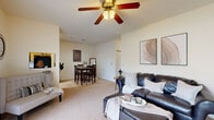 Located at 4499 Coventry Pkwy in Fort Wayne, Indiana, this single-floor residence offers a practical and comfortable layout across two bedrooms and two bathrooms. The living room serves as the heart of the home, featuring a ceiling fan, a tile-surround fireplace, and a large sliding glass door that opens to a private patio overlooking greenery, flooding the space with natural light. Soft carpeting and neutral walls create a warm, cohesive ambiance throughout. The living area flows naturally into the dining space, which provides a dedicated area for meals and gatherings. The kitchen is well-equipped with wood-toned cabinetry, dark appliances including a range, microwave, and refrigerator, laminate countertops, and durable wood-look flooring, with a window above the sink adding natural light. The primary bedroom is a comfortable retreat featuring a ceiling fan, carpeted floors, and a bright window. The second bedroom also offers carpet, natural light, and a ceiling fan. Both bathrooms are finished with wood-tone vanities, granite-style countertops, and wood-look flooring. This residence offers a balanced combination of functionality and comfort in a convenient Fort Wayne location.