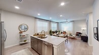 Located at 11918 Clay Road in Houston, TX, this single-story 2-bedroom, 2-bathroom residence offers a well-designed open-concept layout across a comfortable footprint. The kitchen and living room share a seamlessly connected space, anchored by a large granite-topped island with an undermount sink and bar seating — ideal for both cooking and casual dining. The kitchen is equipped with stainless steel appliances, including a French door refrigerator, electric range, and microwave, complemented by taupe cabinetry with a subway tile backsplash. Wood-style flooring flows throughout, adding warmth and visual continuity. The living area features multiple windows that invite abundant natural light, along with a ceiling fan for added comfort. The primary bedroom is generously proportioned, with a ceiling fan, large window, and access to a walk-in closet outfitted with wire shelving systems offering organized storage. The second bedroom is similarly bright and well-appointed. Both bathrooms include granite vanities, dark cabinetry, and tub-shower combinations with white subway tile surrounds. A hallway connects the private areas of the unit, and two dedicated closets contribute to the home's overall storage capacity. The neutral color palette throughout creates a clean, modern ambiance.