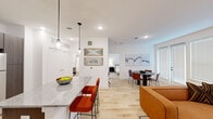 Located at 6519 Kings Glen Drive in Humble, TX, this well-appointed one-bedroom, one-bathroom residence offers a thoughtfully designed open-concept layout that maximizes every inch of its comfortable footprint. Light wood-style flooring flows seamlessly throughout, tying together each living area with a clean, contemporary aesthetic.

The kitchen is a standout feature, showcasing dark wood cabinetry, a full suite of stainless steel appliances including a refrigerator, range, microwave, and dishwasher, and a granite-topped island with pendant lighting and bar seating — ideal for casual dining or entertaining. The open layout connects the kitchen directly to the dining area, which benefits from large windows that invite natural light, and to the living room, which offers a bright, airy atmosphere with recessed lighting and ample space to relax.

The bedroom is a calm retreat with a ceiling fan, a well-sized window for natural light, and carpeted flooring for added comfort. A dedicated closet provides practical storage. The bathroom impresses with a wide double-sink vanity finished in dark wood tones, a granite countertop, a large framed mirror, and stylish contemporary lighting fixtures. The overall design throughout the space is clean, modern, and cohesive, making this residence a refined and functional place to call home.