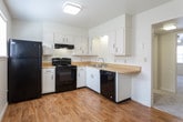 Located at 2125 Arbordale Pl in Dalton, Georgia, this two-floor home offers a straightforward and functional layout with neutral finishes throughout. The kitchen is equipped with white cabinetry, light wood-tone countertops, and black appliances including a refrigerator, electric range, dishwasher, and an over-range exhaust hood. Wood-look flooring runs through the kitchen, adding warmth to the space. The bathrooms feature wood-look flooring as well, with one offering a vanity with a white cabinet base, a large mirror, and brushed nickel fixtures, while another includes a tub-shower combination with a tiled surround. The bedrooms are carpeted in a light neutral tone and are well-proportioned, each receiving natural light through windows with blinds. Several bedrooms include ceiling fans or overhead light fixtures, and at least one features a closet with bi-fold doors. The vaulted ceiling in the primary bedroom area adds a sense of openness. Throughout the home, clean white walls and consistent neutral flooring choices create a cohesive and move-in ready environment. The overall ambiance is calm and practical, well-suited for comfortable everyday living.
