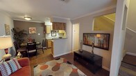 This two-story, 1-bedroom, 1-bathroom residence offers a smart and functional layout across two well-defined levels. The main floor features an open-concept living and dining area, where hardwood-style flooring, crown molding, and neutral-toned walls create a warm and inviting atmosphere. The living room provides ample space for comfortable seating, while the adjacent dining area accommodates a full dining set. A half-wall passthrough connects the living area to the galley-style kitchen, which is outfitted with warm wood cabinetry, laminate countertops, a double-basin sink, a dishwasher, a full-size electric range, and a refrigerator — all arranged efficiently for ease of use.

A staircase leads to the upper level, where the private bedroom awaits. This spacious room features plush carpeting, a ceiling fan with integrated lighting, and a window dressed with curtains, allowing for natural light while maintaining privacy. The bedroom opens to a walk-in closet area, adding to the overall storage of the home. The full bathroom is conveniently located on the upper level, featuring a vanity with countertop space. Throughout both levels, textured ceilings and consistent neutral finishes contribute to a cohesive, comfortable living environment.