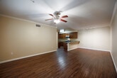 Located in Chula Vista, CA, this well-appointed 3-bedroom, 4-bathroom home offers a thoughtfully designed single-floor layout. The open-concept living and dining area is anchored by rich hardwood-style flooring, crown molding, and a ceiling fan, creating a warm and inviting atmosphere. Natural light filters in through window treatments, enhancing the bright, neutral interior palette.

The kitchen is a standout feature, showcasing rich dark wood cabinetry, granite countertops, stainless steel appliances, and a convenient breakfast bar that seamlessly connects to the dining and living spaces. Ample cabinet storage and a functional layout make this kitchen both practical and stylish.

The generously sized primary bedroom includes a ceiling fan, hardwood-style flooring, and access to a well-appointed en-suite bathroom featuring dual sinks with granite countertops, dark wood vanity cabinetry, tile flooring, and a soaking tub with shower. Additional bedrooms are carpeted and served by their own bathrooms, each mirroring the same quality finishes. The home also includes five closets with wire shelving systems, a dedicated laundry area, a hallway, and a private balcony. The overall ambiance is clean, functional, and move-in ready.