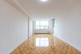 Located at 2677 Kipling Ave in Toronto's northwest end, this 4-bedroom, 2-bathroom unit offers a functional and well-organized single-floor layout. Warm parquet flooring flows throughout the main living areas and bedrooms, lending a classic character to the space. The unit is bathed in natural light, with large windows in several rooms framing outdoor views of the surrounding neighbourhood and greenery.

The four bedrooms are comfortably sized, with the primary bedroom offering generous proportions. Multiple bedrooms feature sliding door closets, providing ample built-in storage. Baseboard heating runs beneath the windows in several rooms, ensuring warmth throughout the colder months.

The two bathrooms are cleanly finished — one features pastel mosaic wall tiling with a white vanity and tile flooring, while the second includes a full bathtub with white subway tile surround. Both are practical and well-maintained.

The hallway connects the rooms efficiently, with tile flooring at the entry transitioning to parquet throughout. A dedicated closet adds additional storage. Textured ceilings and crisp white walls are consistent throughout the unit, creating a bright, neutral palette ready for personalization. This is a well-proportioned home suited for families or shared living in a convenient Toronto location.