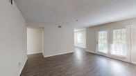 Located at 100 Antioch Pike in Nashville, TN, this single-floor, three-bedroom, one-bathroom home offers a well-organized layout with a clean, neutral aesthetic throughout. The combined living and dining area is spacious and bright, featuring durable wood-look flooring, a textured ceiling, and French doors that invite natural light while providing access to the exterior. The kitchen is equipped with white shaker-style cabinetry, white countertops, a subway tile backsplash, and a full suite of stainless steel appliances including a refrigerator, electric range, microwave, and dishwasher. Three bedrooms each feature wood-look flooring and ceiling fans, with the primary bedroom offering a notably generous footprint. The shared full bathroom includes a single-sink vanity with a light stone countertop, a large mirror, and a tub-shower combination with tile surround. Storage is well-addressed throughout the home with four closets, including wire-shelved walk-in style closets. A utility room and hallway connect the spaces efficiently, completing this practical and neatly finished single-level home in Nashville.