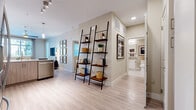 Located at 13250 Foothill Blvd in Rancho Cucamonga, CA, this one-bedroom, one-bathroom residence offers a thoughtfully designed single-floor layout with a bright, contemporary aesthetic. Light wood-style flooring flows through the main living areas, creating a clean and cohesive look throughout.

The open-concept kitchen and living room form the heart of the home. The kitchen is equipped with stainless steel appliances, including a gas range, refrigerator, and built-in microwave, complemented by white upper cabinetry, two-tone lower cabinetry, and light countertops. The adjacent living area features large windows and a glass door that invite abundant natural light, with a wall-mounted TV and ample space for relaxed entertaining.

The bedroom is a comfortable retreat, carpeted for warmth, with multiple windows offering natural light, a ceiling fan, and generous wall space. It connects to a dedicated walk-in closet with built-in shelving and hanging rods. The full bathroom features a wide vanity with white cabinetry, a large mirror, light tile flooring, and a shower-tub combination.

A hallway lined with ladder-style shelving adds a stylish, functional touch, connecting the living spaces to the private areas. The overall ambiance is modern, warm, and well-organized.