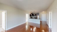 Located at 200 Dominion Oak Cir in Cary, NC, this well-appointed single-floor residence offers three bedrooms, four bathrooms, and a thoughtfully designed layout. The kitchen is a standout feature, showcasing rich dark cabinetry, granite countertops, a classic subway tile backsplash, stainless steel appliances including a refrigerator, range, and microwave, and a peninsula with pendant lighting that opens to the living area. Rich hardwood flooring flows throughout the main living spaces, adding warmth and continuity.

The primary bedroom is a generously sized retreat with plush carpeting and direct access to a private en-suite bathroom featuring a lengthy dual-sink vanity topped with dark granite, dark cabinetry, and tile flooring. Additional bathrooms are equally well-finished, with one offering a tub-shower combo with tiled surround and another featuring a walk-in shower. The secondary bedrooms are carpeted and bright, benefiting from large windows that invite natural light and offer views of the surrounding area. One bedroom includes sliding glass doors for added versatility. A dedicated closet rounds out the functional layout, making this a practical and attractive residence in a desirable Cary location.