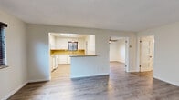 Located in Long Beach, California, this single-story 2-bedroom, 2-bathroom home offers a well-designed layout with modern finishes throughout. The living room greets you with a bold black front door featuring a transom window, light wood-tone luxury vinyl plank flooring, and a large window fitted with horizontal blinds that invite natural light into the space.

The kitchen is equipped with white cabinetry, a warm-toned tile backsplash, a double basin sink, and a window overlooking an adjacent area, lending the space a bright and functional character. The layout connects efficiently to the rest of the home via a hallway.

Both bedrooms are finished with light wood-tone flooring and windows with blinds. The primary bedroom is a generously sized retreat featuring full-wall mirrored sliding closet doors that enhance the sense of space. The second bedroom is equally well-lit and comfortable, with a ceiling fan visible in the adjoining area.

The two bathrooms offer distinct configurations: one features a sleek walk-in shower enclosed by sliding glass doors with stylish mosaic tile flooring and brushed nickel fixtures, while the second bathroom includes a tub-shower combination with a sliding glass enclosure and a white vanity with ample storage. Both bathrooms are finished with light flooring and clean, neutral tones throughout.
