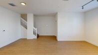 This contemporary townhouse in Miramar, Florida offers 1040 square feet of well-designed living space across two floors. The ground floor spans 490 square feet, while the upper level provides 550 square feet. The home features two bedrooms, including a generous 180 square foot primary bedroom, and two full bathrooms.

The heart of the home is a sleek, open-concept kitchen showcasing light-colored cabinetry, stainless steel appliances, and a large center island with granite countertops. Track lighting and pendant fixtures add a modern touch. The kitchen flows seamlessly into the living and dining areas, which boast wood-look flooring and ample natural light.

Both bathrooms are tastefully appointed with granite vanity tops, modern fixtures, and glass-enclosed showers. The master bath features dual sinks for added convenience. A dedicated laundry room with full-sized washer and dryer adds practicality to the home.

The exterior of the townhouse is equally impressive, with a paved patio area surrounded by lush tropical landscaping, including palm trees. This outdoor space provides an ideal setting for relaxation or entertaining.

Throughout the home, neutral tones and clean lines create a bright, airy atmosphere. Additional features include ceiling fans, window blinds, and closet systems for ample storage. Located in the desirable Miramar area, this townhouse offers a perfect blend of style, comfort, and convenience.