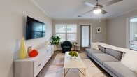 This thoughtfully designed 3-bedroom, 3-bathroom single-floor home in Concord, NC offers a comfortable and modern living experience. The open-concept kitchen and living area serve as the heart of the home, with the kitchen featuring sleek gray cabinetry, granite countertops, and a full suite of stainless steel appliances. Crown molding and wood-look flooring carry through the living room, which is bathed in natural light from multiple windows and finished with a ceiling fan for year-round comfort.

Each of the three bedrooms is carpeted and equipped with a ceiling fan, offering a cozy retreat. The primary bedroom includes a walk-in closet with built-in shelving. The additional bedrooms also benefit from natural light through bright, window-fitted walls with outdoor views. All three bathrooms are finished with granite-topped vanities and gray cabinetry, with wood-look tile flooring tying the design together cohesively.

A dedicated laundry room houses a full-size washer and dryer alongside an additional storage closet with wire shelving. Two closets throughout the home provide ample storage. The neutral, warm color palette and consistent finishes create a clean, modern ambiance throughout this well-appointed Concord residence.