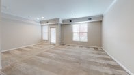 Located at 50 Turnberry Ct in Bear, Delaware, this single-floor residence offers a well-designed layout with a clean, neutral aesthetic throughout. The open living area features plush wall-to-wall carpeting, warm beige tones, crown molding details, and multiple windows that invite natural light while providing views of the surrounding greenery. The space flows seamlessly into a breakfast bar that connects to the kitchen.

The kitchen is a standout feature, equipped with crisp white shaker-style cabinetry, dark granite countertops, and a classic subway tile backsplash. Stainless steel appliances — including a French door refrigerator, electric range, built-in microwave, and dishwasher — complement the light hardwood-style flooring that runs throughout this area.

The bedrooms are generously sized, carpeted for comfort, and finished with the same neutral wall palette, providing a calm and versatile canvas. The bathroom is well-appointed with tile flooring, a dual-sink vanity with white cabinetry, a large mirror, and a full soaking tub with shower combination. A set of double doors leads to a spacious closet, adding practical storage.

Overall, this residence presents a fresh, move-in-ready environment with consistent finishes and a functional, comfortable layout.
