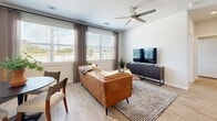 Located at 1575 League Line Rd in Conroe, TX, this single-story residence offers a thoughtfully designed layout with a clean, contemporary aesthetic throughout. Light wood-style flooring flows seamlessly across every room, complementing the neutral, warm color palette that creates a welcoming ambiance.

The kitchen is a standout feature, showcasing crisp white shaker cabinetry, granite countertops, a classic subway tile backsplash, and a full suite of stainless steel appliances including a French door refrigerator and electric range. A center island with sink provides additional prep space and casual seating opportunities.

The dining area is bathed in natural light from large windows overlooking lush greenery, creating an inviting atmosphere for everyday meals. The living area similarly benefits from generous window placement, offering bright, airy surroundings.

The bedrooms are generously sized and feature large windows that frame outdoor views. Each bedroom is served by a walk-in closet outfitted with wire shelving for organized storage. The bathrooms are elegantly appointed with granite-topped white vanities, wood-look flooring, and tub-shower combinations accented by striking marble-style tile surrounds. The overall design balances modern finishes with comfortable, livable spaces throughout.