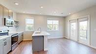 Located at 1417 Hampton Avenue Ext in Greenville, SC, this well-appointed 2-bedroom, 2-bathroom residence offers a thoughtfully designed single-floor layout with a clean, contemporary aesthetic throughout. The open-concept kitchen and living area forms the heart of the home, anchored by a central island with a white quartz countertop and undermount sink. The kitchen features gray shaker-style cabinetry, stainless steel appliances including a refrigerator, range, and over-the-range microwave, along with open shelving and hardwood-style flooring. The adjacent living area is bright and airy, filled with natural light from multiple windows and access to a private balcony, complemented by a ceiling fan overhead. Both bedrooms are carpeted and well-sized, with the primary bedroom offering a comfortable retreat supported by its own dedicated closet. The primary bathroom includes a glass-enclosed walk-in shower, a vanity with quartz countertops, and gray cabinetry. The second bathroom mirrors the modern finishes with a combination tub and shower, a wide vanity, and tile flooring. Neutral wall tones and recessed lighting tie the entire space together with a fresh, move-in-ready feel.