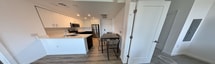 This 690 square foot apartment in Sacramento maximizes space efficiency with a thoughtful layout. The modern kitchen boasts white cabinetry, stainless steel appliances, and a peninsula with seating. The living room features wood-look flooring, recessed lighting, and a large window offering city views. The versatile second room serves as both an office and additional sleeping space, with built-in desks and beds. Two bathrooms provide convenience, one with a shower/tub combo and subway tile, the other with a sleek vanity and modern fixtures. The primary bedroom, measuring 140 square feet, completes the space. Throughout, the apartment showcases a neutral color palette, clean lines, and ample natural light, creating a contemporary urban living environment. The unit's smart design incorporates storage solutions and multi-functional spaces, making it ideal for those seeking a compact yet comfortable city dwelling.