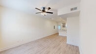 Located at 615 Tiny Town Rd in Clarksville, TN, this two-story, 2-bedroom, 3-bathroom home offers a clean, modern aesthetic across two thoughtfully arranged floors. The main level features an open-concept kitchen and living area finished with light luxury vinyl plank flooring throughout. The kitchen is a standout space, showcasing gray shaker-style cabinetry with matte black hardware, quartz countertops, a peninsula with pendant lighting, stainless steel appliances, and a black undermount sink — all bathed in natural light from multiple windows. The living area is accented by a ceiling fan and a welcoming front entry. The main level also includes a full bathroom with quartz vanity, an oval mirror, and a tub-shower combination. Upstairs, two comfortable bedrooms feature plush carpet flooring and ceiling fans, with the primary bedroom offering generous proportions. The upper level is completed by additional bathrooms and a dedicated laundry area. Throughout the home, neutral wall tones, crisp white trim, and consistent finishes create a bright, cohesive atmosphere well-suited for comfortable everyday living.