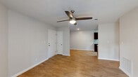 Located at 1515 Hogansville Rd in LaGrange, Georgia, this single-story, 2-bedroom, 2-bathroom home offers a clean, modern aesthetic with thoughtful design throughout. The living room is bright and welcoming, featuring warm hardwood-style flooring, a ceiling fan with light fixture, and French doors that invite natural light and provide outdoor access. The adjacent dining area flows seamlessly into the kitchen, which is equipped with rich dark cabinetry, granite-look countertops, a tile backsplash, and brushed nickel fixtures. Both bedrooms are comfortably sized, carpeted for warmth, and each includes a ceiling fan and closet space. The primary bedroom is a generous retreat with ample room for furnishings. The two full bathrooms are well-appointed with white tub-shower combinations, granite-look vanity countertops, dark wood cabinetry, and brushed nickel hardware. A dedicated laundry area and utility room add everyday convenience. The hallway connects the living spaces efficiently, while multiple closets throughout provide practical storage. Neutral wall tones and consistent finishes create a cohesive, move-in-ready ambiance across the entire home.