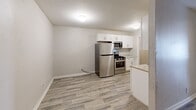 Located at 405 Hale St in Augusta, Georgia, this 2-bedroom, 1-bathroom home offers a practical and well-designed single-floor layout. The interior features consistent wood-look tile flooring throughout, lending a cohesive and modern aesthetic to each room.

The kitchen is a functional highlight, outfitted with white shaker-style cabinetry, granite-look countertops, a stainless steel sink, and a full suite of stainless steel appliances including a refrigerator, gas range, and over-the-range microwave. The adjacent dining or living area provides an open extension of the kitchen space.

Both bedrooms are comfortably sized, each equipped with a ceiling fan with light fixture and a window fitted with blinds, allowing for natural light and airflow. The neutral warm-gray wall tones create a calm, welcoming atmosphere throughout.

The full bathroom includes a single-sink vanity with granite-look countertop, white cabinetry, a full tub-shower combo with built-in shelving, and wood-look tile flooring that ties in with the rest of the home.

Completing the layout is a hallway connecting the main living areas, along with a staircase. The home's clean, neutral palette and updated finishes make it a move-in ready residence in Augusta's historic downtown area.