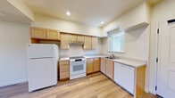 Located at 80 Dovetail Lane in the charming wine country town of Healdsburg, CA, this 2-bedroom, 1-bathroom single-floor home offers a clean, modern design with a practical and comfortable layout. Light wood-tone flooring runs consistently throughout, lending warmth and visual continuity to every room.

The kitchen is well-equipped and features light maple cabinetry with ample upper and lower storage, white appliances including a refrigerator, electric range, and dishwasher, plus a double sink positioned beneath a window that allows natural light to fill the workspace. Recessed lighting and generous counter space add to the kitchen's functionality.

Both bedrooms are bright and airy, each featuring windows that invite natural light and views of the surrounding neighborhood. The primary bedroom includes a sliding-door closet, offering convenient built-in storage. The second bedroom, while compact, is equally light-filled and versatile.

The full bathroom is clean and simply appointed, featuring a tub-shower combination with a curved curtain rod, a toilet, and the same warm wood-look flooring found throughout the home. Two hallways connect the living areas and provide additional flow through the space.

Overall, the home presents a fresh, neutral palette with a cohesive modern aesthetic, making it a functional and inviting residence in Northern California's Sonoma County.