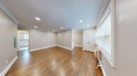 Located at 340 Park Street in Hackensack, NJ, this well-appointed one-bedroom, one-bathroom unit offers a thoughtfully designed single-floor layout. Warm hardwood flooring runs throughout the space, complemented by crisp crown molding and recessed lighting that create a clean, polished aesthetic. The open combined living and dining area provides a comfortable, versatile space with neutral taupe walls and natural light from a window overlooking the outdoors. The kitchen is efficiently laid out and connects naturally to the living area. The bedroom is a well-proportioned retreat featuring a ceiling fan with light fixture, a window with blinds, and its own closet access. Ample storage is provided throughout, with four closets in total distributed across the unit. The bathroom is neatly finished with white subway tile surrounding a soaking tub and shower combination, accented by a mosaic tile border, a dark wood vanity, and a medicine cabinet mirror — all brought together with chrome fixtures. An in-unit laundry area adds everyday convenience. Recessed lighting throughout maintains a bright, modern feel, making this a functional and comfortable residence in Hackensack.