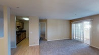 Located at 800 E Lexington in El Cajon, unit #221 is a single-floor residence offering a well-organized layout with distinct living, dining, and sleeping areas. The open living room features neutral-toned carpet, smooth walls, and a sliding glass door with vertical blinds that allows natural light to fill the space. Adjacent to the living area, a dedicated dining space is highlighted by an elegant multi-bulb chandelier and a pass-through window connecting to the kitchen.

The galley-style kitchen is well-appointed with light wood cabinetry, dark granite countertops, a double stainless steel sink, and hardwood-style flooring. Stainless steel appliances, including a refrigerator, microwave, and electric range, complete the functional setup. A spacious bedroom offers plush carpeting and a window with blinds that brings in natural light.

Two full bathrooms mirror each other in design, each featuring a tub-shower combination with tile surround, a granite-topped vanity with an vessel-style sink, a large mirror, and warm lighting. A convenient in-unit stacked washer and dryer is tucked neatly into a dedicated alcove, adding to the practicality of this well-designed residence.