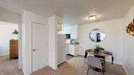 Located at 6501 Eastridge Rd in Odessa, Texas, this single-floor residence offers a well-organized layout designed for comfortable everyday living. The kitchen is efficiently arranged with white cabinetry, granite-style countertops, hardwood-style flooring, and a full suite of appliances including an electric range, built-in microwave, and dishwasher — providing ample workspace and storage for home cooking. Adjacent to the kitchen, the dining area features carpet flooring and flows naturally into the living space, creating a cohesive open feel. The living room is bright and inviting, with a ceiling fan, a window dressed with navy curtains allowing natural light, and neutral walls that lend themselves to a variety of décor styles. The bedroom is generously sized with soft carpet flooring, a ceiling fan, and a window with natural light, offering a calm and restful retreat. Textured ceilings are a consistent architectural detail throughout the home. The bathroom is clean and functional, featuring a tub-shower combination, hardwood-style flooring, and granite-style countertop vanity. Overall, the space presents a practical and comfortable living environment with a neutral palette and well-maintained finishes throughout.