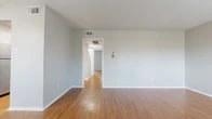 Located at 2200 W Lowden St in Fort Worth, TX, this two-bedroom, one-bathroom single-floor home offers a practical and well-organized layout. Warm hardwood-style flooring runs consistently throughout every room, lending a cohesive and clean aesthetic to the entire space.

The living room is comfortably sized and benefits from natural light through a window dressed with blinds, along with a ceiling fan that enhances comfort year-round. A hallway connects the living area to the rest of the home, providing a clear and intuitive flow between spaces.

The galley-style kitchen is efficiently designed, featuring white cabinetry, granite-look countertops, a gas range with oven, a dishwasher, and an overhead exhaust hood — providing everything needed for everyday cooking.

Both bedrooms are well-proportioned and bright. The primary bedroom includes a ceiling fan with a light fixture and a window that admits natural light. The second bedroom offers generous closet storage, including built-in shelving. A third image reveals a room with two closets, adding notable storage capacity.

The bathroom is neatly finished with wood-style flooring, a toilet, and a tub-shower combination accented by classic white subway tile surround, adding a timeless, clean touch to the space.