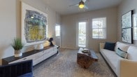 This single-floor residence offers a thoughtfully designed layout with a contemporary aesthetic carried consistently across every room. Light wood-style flooring flows throughout the unit, complementing neutral wall tones that create a bright, cohesive interior.

The kitchen is a standout feature, equipped with dark espresso cabinetry extending to the ceiling for generous storage, a mosaic tile backsplash, white quartz-style countertops, and a full suite of stainless steel appliances including a side-by-side refrigerator, electric range, and over-the-range microwave.

The living area benefits from multiple windows and a glass-panel door that invite abundant natural light, while a ceiling fan adds functional comfort. The space comfortably accommodates a full seating arrangement.

Two well-proportioned bedrooms each feature natural light from sizable windows. The primary bedroom includes a softly lit, serene ambiance, while the second bedroom offers outdoor views and ample floor space.

Two bathrooms serve the residence: one features a tiled tub-shower combination with a framed vanity mirror and dark cabinetry, while the second offers a glass-enclosed walk-in shower with clean tile surround and matching finishes.

A dedicated in-unit laundry area with full-size washer and dryer adds everyday convenience.