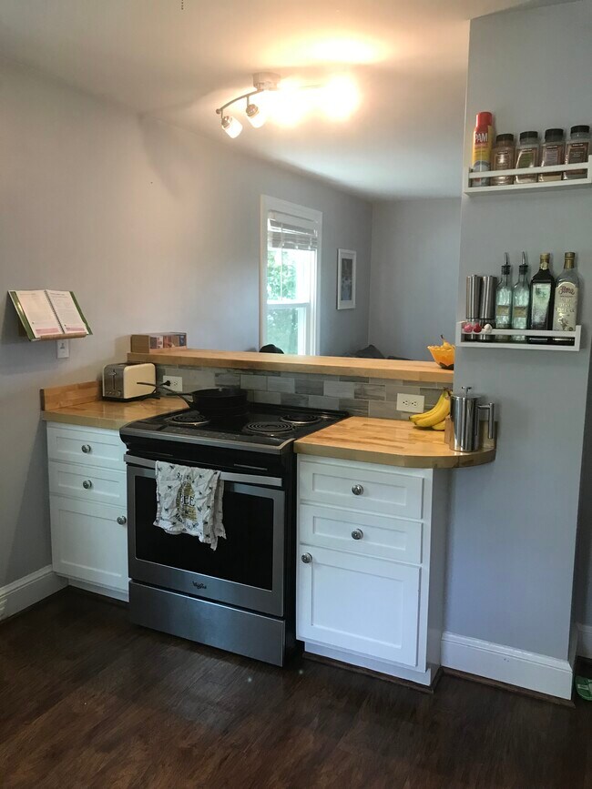 Counters, toaster, cabinets, and stove adjacent to bartop - 915 Montrose Ave