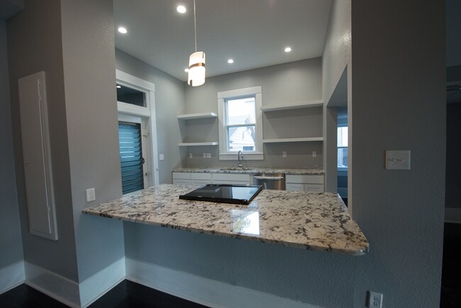 Eat in kitchen island with modern cabinets, granite and appliances. - 714 Gillespie St