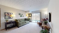 This well-appointed 2-bedroom, 1-bathroom residence in Columbus, Ohio offers a thoughtfully designed single-floor layout that maximizes comfort and functionality. The spacious living room serves as the heart of the home, featuring plush carpeting, a textured ceiling, and a large sliding glass door that floods the space with natural light while framing tranquil views of surrounding trees. The sliding door opens directly to a private patio, seamlessly blending indoor and outdoor living.

The kitchen is efficiently laid out with warm oak cabinetry, tile flooring, a double sink, and includes essential appliances. A hallway connects the living areas to the private quarters, where two carpeted bedrooms provide restful retreats. The primary bedroom features a decorative textured ceiling and a generous walk-in closet with wire shelving and ample hanging space. The second bedroom includes a built-in closet with sliding doors. Both rooms offer a calm, neutral palette.

The full bathroom is finished with tile flooring, an oak vanity with a large mirror, and a well-lit vanity fixture above. Throughout the residence, warm wood trim, neutral tones, and carpeted floors create a cohesive and inviting ambiance, making this a comfortable home in a peaceful setting.