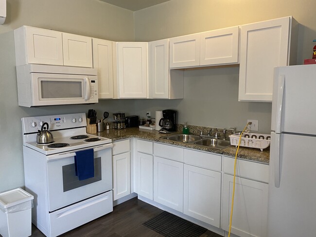 Kitchen with stove and fridge - 653 Delgado St