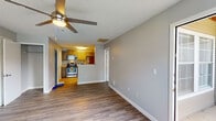 Located at 317 Lynn Rd in Raleigh, NC, this single-floor unit offers a practical and comfortable layout designed for everyday living. The open living area features durable wood-style plank flooring and a ceiling fan with light, creating a bright and airy atmosphere. Neutral gray walls throughout provide a clean, modern backdrop that complements any décor.

The kitchen is efficiently designed with warm-toned cabinetry, granite-style countertops, and a full suite of stainless steel appliances, including a gas range, built-in microwave, and refrigerator. A pass-through counter connects the kitchen to the living space, enhancing the open feel of the unit.

The bedroom is a comfortable retreat, finished with plush carpeting, a ceiling fan, and windows with blinds that allow for natural light and privacy. A dedicated closet with built-in wire shelving provides ample storage.

The full bathroom includes a single-sink vanity with cabinet storage, a toilet, and a tub/shower combination. Wood-style flooring continues into the bathroom, maintaining a cohesive aesthetic throughout the space.

Additional storage is accessible via a hallway closet. The unit's straightforward single-floor layout makes for easy navigation, and its location in Raleigh's 27609 zip code places it within a well-connected area of the city.