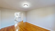 Located at 50 W Maple Ave in Merchantville, NJ, this two-bedroom, one-bathroom residence offers a well-organized, single-floor layout with a clean and bright aesthetic throughout. Warm-toned hardwood floors run consistently through the living room, hallway, and both bedrooms, lending a cohesive and inviting feel to the entire space.

The living room is a comfortable, open area that receives ample natural light through a front-facing window and features a baseboard heating unit. A charming arched doorway connects the living room to the kitchen, adding a classic architectural detail. The kitchen is equipped with white cabinetry, a gas range, a stainless steel sink, and light vinyl flooring, with two windows providing views of the surrounding greenery.

The primary bedroom is a well-proportioned room featuring a built-in closet and direct access to the hallway. The second bedroom also showcases hardwood floors, a baseboard heater, and a window for natural light. Both bedrooms maintain the same neutral color palette seen throughout the home.

The bathroom is finished with crisp white subway tile surrounding a full tub-shower combination, complemented by a frosted window for privacy and natural light. The overall ambiance of the space is clean, functional, and move-in ready.