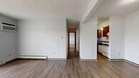 Located at 2608 Pioneer Trail in Sandusky, Ohio, this single-floor unit offers a practical and straightforward layout across several well-defined living spaces. The open living and dining area is finished with durable wood-look plank flooring and features a baseboard heating system, a wall-mounted air conditioning unit, and a sliding glass door fitted with vertical blinds that allows natural light to fill the space and provides access to an outdoor area. A dedicated entry area with a full-size door connects to the main living space, maintaining a clear sense of flow throughout.

The kitchen is positioned adjacent to the living area and is equipped with rich wood cabinetry, dark laminate countertops, a double-basin sink, a dishwasher, a coil-burner electric range with overhead exhaust, and continued wood-look flooring. A hallway leads from the main living area to the private quarters of the unit.

The bedrooms feature neutral wall-to-wall carpeting, baseboard heaters, and windows with blinds that provide natural light. Closet access is available within the bedroom area. The full bathroom includes a tiled tub-and-shower combination, a single-sink vanity with a mirrored medicine cabinet, and wood-look flooring, completing the unit's functional design.