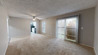This single-story, 2-bedroom, 2-bathroom residence offers a practical and comfortable layout across a well-organized floor plan. The spacious living room serves as the heart of the home, featuring neutral-toned carpet, a ceiling fan, a textured ceiling, and a large sliding glass door fitted with vertical blinds that floods the room with natural light and provides direct access to an outdoor patio with views of surrounding greenery.

The kitchen is appointed with crisp white cabinetry, granite-look countertops, a stainless steel sink, and wood-look vinyl plank flooring. Black appliances, including a refrigerator and range, provide a striking contrast to the bright cabinetry, while ample counter and storage space make the kitchen highly functional.

Both bedrooms are carpeted and painted in a cool gray tone, each featuring natural light from windows with outdoor views. The primary bedroom stands out with dual reach-in closets, offering generous storage capacity. The second bedroom also includes a reach-in closet. Two hallways connect the bedrooms and living areas efficiently throughout the unit.

The bathrooms are finished with wood-look tile flooring, white vanities, and full tub-shower combinations, maintaining a clean and cohesive aesthetic. Two hallways ensure smooth circulation throughout the home, completing this efficiently designed and move-in ready residence.