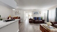 Located at 962 W Second St in Rialto, California, this single-story, three-bedroom home offers a well-designed layout that balances comfort and functionality. The open-concept living and dining area features wood-look flooring, neutral-toned walls, and large windows dressed with elegant drapes that fill the space with natural light. A textured ceiling adds character throughout the main living areas.

The kitchen is a standout feature, showcasing crisp white cabinetry, granite-style countertops, a peninsula with bar seating, and a full suite of stainless steel appliances. A window above the sink provides natural light, making the kitchen both practical and inviting. The adjacent dining area offers an intimate setting, complemented by the same warm flooring and soft neutral palette.

The expansive primary bedroom is a true retreat, featuring plush carpeting, a sliding glass door with outdoor views, and a dedicated walk-in closet offering generous storage. Two additional bedrooms provide flexibility for various living needs. A hallway connects the bedrooms efficiently to the main living spaces.

A large walk-in closet serves as a dedicated storage area, while the overall floor plan ensures a smooth, connected flow between all rooms. The landscaped exterior, visible in the point cloud scan, adds to the home's curb appeal in this Rialto neighborhood.