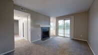 Located at 8335 Hyannis Port Dr in Dayton, Ohio, this one-bedroom, one-bathroom residence offers a thoughtfully designed single-floor layout. The living room serves as the centerpiece of the home, featuring a tile-surround wood-burning fireplace with a crisp white mantel and plush carpeting underfoot. Sliding glass doors flood the space with natural light and open directly onto a private balcony with outdoor views, seamlessly connecting the living and dining areas to the outdoors. The galley-style kitchen is well-equipped with white cabinetry, granite countertops, a stainless steel sink, and black appliances, with light wood-look flooring adding a clean, modern touch. A dedicated laundry room houses a full-size washer and dryer on durable vinyl plank flooring, adding everyday convenience. The carpeted bedroom offers a comfortable retreat with a large window that brings in natural light and scenic outdoor views, complemented by a spacious closet. The bathroom features a full soaking tub and shower enclosed in classic white subway tile. Neutral gray tones throughout the home create a cohesive, move-in-ready ambiance ideal for comfortable living.