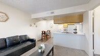 Located at 2060 N Trekell Rd in Casa Grande, AZ, this one-bedroom, one-bathroom unit offers a practical and well-organized single-floor layout. The open-concept living and dining area provides a comfortable shared space, featuring carpet flooring, a textured ceiling, and a window that allows natural light to filter in. Decorative wall accents add a welcoming touch to the living area.

The kitchen runs in a galley-style configuration, showcasing wood-tone cabinetry, light countertops, wood-look vinyl flooring, and white appliances including a range and full-size refrigerator. A utility area provides additional functional space within the unit.

The bedroom is a cozy, carpeted retreat with a window dressed in curtain panels, offering a quiet and private atmosphere. An open sightline connects the bedroom to the living area, enhancing the sense of flow throughout the space.

The bathroom features wood-look flooring, a wood-tone vanity with a light countertop, and a full tub-shower combination with clean white tile surround. The overall design is neutral and understated, with warm tones throughout that create a cohesive and livable environment well-suited for comfortable everyday living.