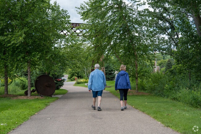 A pair of people walking in Swing Bridge Park in the Inver Grove Heights neighborhood.