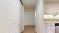 Located at 13999 Marquesas Way in the desirable Marina del Rey neighborhood of Los Angeles, this single-floor residence offers a well-designed layout with one bedroom and three bathrooms. Light wood-style flooring flows consistently throughout the space, creating a clean and cohesive aesthetic. The open living area is anchored by a fireplace and benefits from abundant natural light through large windows dressed with vertical blinds, with sliding glass doors leading to a private balcony that overlooks mature trees and the surrounding neighborhood. The galley-style kitchen is well-appointed with white shaker cabinetry, granite countertops, stainless steel appliances including a range, microwave, refrigerator, and dishwasher, and recessed lighting overhead. An adjacent dining area features a large window with a garden view and track lighting above. The generously sized primary bedroom offers corner windows that flood the room with natural light. The bathrooms are finished with white cabinetry, granite vanity countertops, and sliding glass-enclosed tub and shower combinations. The private balcony, accessible via sliding glass door, provides an outdoor retreat with a modern metal railing and peaceful tree-lined views.