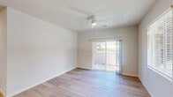 Located at 3786 Horizons Ave in Merced, CA, this single-story, 3-bedroom, 2-bathroom home offers a clean, modern design throughout. Light wood-tone flooring runs continuously across all rooms, creating a cohesive and welcoming atmosphere. The open kitchen and living area serves as the heart of the home, featuring a well-appointed kitchen with warm wood cabinetry, white countertops, stainless steel appliances including a refrigerator, electric range, microwave, and dishwasher, and a deep single-basin sink. The living area is bright and airy, with multiple windows dressed in blinds that invite natural light. The spacious primary bedroom offers a comfortable retreat, while the two additional bedrooms are well-sized with clean white walls and ample natural light. Both bathrooms are finished consistently with wood-tone vanities, white countertops, light wood flooring, and accessibility grab bars. The primary bath features dual vanities for added convenience. A dedicated laundry room houses a full-size side-by-side washer and dryer with overhead shelving. A hallway connects the bedrooms and living spaces efficiently, completing this well-designed, move-in-ready home.