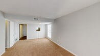This two-story residence offers two bedrooms and one and a half bathrooms across a well-organized layout. The main level features a carpeted living room with a large window that allows natural light to fill the space, creating a bright and open atmosphere. A six-panel front door adds a classic architectural touch to the entryway. The kitchen is equipped with white cabinetry, speckled laminate countertops, a double-basin sink positioned beneath a window, and a dishwasher, providing a practical and functional workspace.

A pass-through window connects the kitchen to the adjacent living area, enhancing the sense of openness between spaces. The main level also includes a half bathroom for added convenience.

Upstairs, both bedrooms are carpeted and feature ceiling fans with integrated lighting, textured ceilings, and windows that bring in natural light. One bedroom includes dual closets, offering generous storage capacity. The full bathroom on this level is fitted with a tiled tub-shower combination, a toilet, and wood-look flooring. Neutral gray walls and light carpet tones are consistent throughout, giving the home a clean, cohesive appearance.