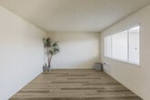 Located at 200 Hollis Ave in Campbell, CA, this single-story 1-bedroom, 1-bathroom residence offers a thoughtfully designed layout that makes efficient use of its comfortable floor area. The living room is bright and open, featuring light-toned luxury vinyl plank flooring, neutral cream walls, a textured ceiling, and large windows fitted with horizontal blinds that invite natural light while maintaining privacy. A wall-mounted HVAC unit ensures year-round comfort.

The kitchen is efficiently arranged in a galley-style configuration, showcasing white cabinetry, granite-style countertops, a full suite of white appliances including an electric range and refrigerator, and LVP flooring that continues throughout the common areas. Adjacent to the kitchen, a dining nook benefits from a ceiling fan and a window overlooking the outdoors.

The spacious primary bedroom is carpeted for warmth and comfort, featuring multiple windows that fill the room with natural light and a sliding closet with built-in rod and shelving for organized storage. The full bathroom is clean and functional, offering a granite-topped vanity with white cabinetry, a full tub-shower combination, and LVP flooring. The overall ambiance throughout is bright, neutral, and move-in ready.