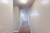 Located at 2451 Chase Park Dr in Montgomery, Alabama, this single-floor residence offers 2 bedrooms and 2 bathrooms within a well-organized layout. The open-concept living, dining, and kitchen area forms the heart of the home, with the living room featuring plush carpeting, a ceiling fan, and a set of French doors that open to a private patio, allowing natural light to fill the space. The galley-style kitchen is well-appointed with warm oak cabinetry, light countertops, a double-basin sink, and black appliances including a range and refrigerator, complemented by wood-look flooring and a skylight panel overhead. Two carpeted bedrooms offer comfortable retreats, with the primary bedroom providing a generous footprint and natural light from a large window. Both bathrooms are finished with wood-look flooring and include full tub-shower combinations. A dedicated laundry area adds everyday convenience. The residence also features an impressive six closets throughout, ensuring ample storage. Textured ceilings and neutral wall tones carry consistently throughout, while carpeted hallways connect the rooms in a cohesive and functional flow.