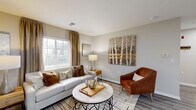 Located at 4048 Battleground Ave in Greensboro, NC, this well-appointed one-bedroom, one-bathroom residence offers a thoughtfully designed single-floor layout that maximizes every square foot. The entryway welcomes you with wood-look flooring and neutral gray walls that carry seamlessly throughout the main living areas, creating a cohesive and calming aesthetic.

The open-concept living, dining, and kitchen area serves as the heart of the home. The living room features a bright window dressed with elegant gold drapes, flooding the space with natural light. The kitchen is equipped with stainless steel appliances, including a full-size refrigerator, and is complemented by white cabinetry and a casual dining area nearby.

A hallway connects the main living space to the private bedroom, which is carpeted for comfort and offers a generous closet for storage. The full bathroom features a tub-shower combination with wood-look flooring that ties into the rest of the home's design language.

A dedicated laundry area with a full-size washer and dryer adds a practical convenience rarely found at this scale. Clean lines, soft neutral palettes, and consistent finishes throughout give this residence a modern yet inviting character ideal for comfortable everyday living.
