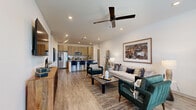Located in Ocala, FL, this well-designed 2-bedroom, 2-bathroom residence offers a thoughtful open-concept layout that seamlessly connects the living, dining, and kitchen areas. Wood-look flooring flows throughout, complemented by recessed lighting and ceiling fans that enhance the bright, airy atmosphere.

The living room is generously proportioned, featuring large windows that invite abundant natural light and a ceiling fan overhead. The modern kitchen is a standout, showcasing light wood cabinetry extending to the ceiling, stainless steel appliances, a tile backsplash, and a spacious island with quartz countertops and bar seating for multiple guests — ideal for both everyday living and entertaining.

The primary bedroom is a comfortable retreat, offering a ceiling fan, large windows, and its own dedicated walk-in closet with built-in shelving and hanging rods. The en-suite primary bathroom features a dual-sink vanity with light wood cabinetry, quartz countertops, framed mirrors, and a glass-enclosed walk-in shower. The second bedroom is equally inviting, with natural light and a ceiling fan. The second bathroom provides a full vanity and a tub-shower combination. Both closets offer practical storage solutions, completing this well-appointed residence.