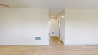 Located at 3634 Spencer St in Torrance, CA, this single-floor, 2-bedroom, 1-bathroom home offers a thoughtfully laid-out living space with a clean, neutral aesthetic throughout. The open living area is anchored by light wood-tone flooring and a large picture window that fills the room with natural light and offers pleasant outdoor views, creating an airy and welcoming atmosphere. A ceiling fan adds both style and comfort to the space.

The kitchen features white cabinetry, white countertops, and a peninsula with bar-style seating — ideal for casual dining. A window above the sink brings in additional natural light, and a range with overhead ventilation hood completes the functional layout. The kitchen flows seamlessly into the living area, supported by matching light wood flooring.

Both bedrooms are carpeted in a soft, neutral tone and equipped with ceiling fans. The primary bedroom offers a generous footprint with a large sliding-door closet providing ample storage. The second bedroom is similarly comfortable with clean walls and a window for natural light.

The bathroom is bright and well-maintained, featuring a combined shower and bathtub with white tile surround, a toilet, and a window for ventilation. Throughout the home, the consistent use of light colors, natural light, and simple finishes creates a calm, livable environment.