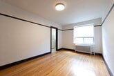 Located at 49 Dundonald Street in Toronto's vibrant Church-Wellesley Village, this 2-bedroom, 2-bathroom unit offers a classic character-filled interior within a compact footprint. Throughout the space, warm hardwood flooring and distinctive dark wood trim and baseboards lend a traditional architectural charm consistent with the building's heritage character.

The primary bedroom is a well-proportioned room featuring a window that brings in natural light and a cast iron radiator, reflecting the building's classic construction. A second bedroom provides additional flexibility for use as a guest room or office. Both bedrooms share the consistent hardwood flooring and dark trim detailing found throughout.

The entry area features rich, dark-stained double wooden doors alongside a secondary door, creating a welcoming and practical entrance with a classic aesthetic. A textured ceiling and panel-rail wall detailing further reinforce the period character of the unit.

The kitchen is efficiently laid out with white lower cabinetry, warm wood upper cabinets, granite-style countertops, white subway tile backsplash, and a classic black-and-white mosaic tile floor. White appliances including an electric range and refrigerator complete the functional space.

The bathroom includes a pedestal sink, a tiled bathtub with shower, and dark marble-style floor tiles, offering a clean and timeless finish. A second bathroom adds convenience to the overall layout.